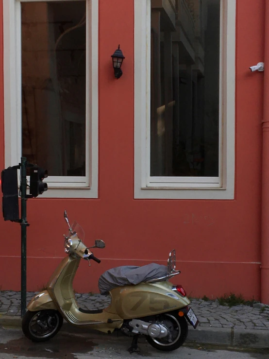 a scooter parked next to a building with no door