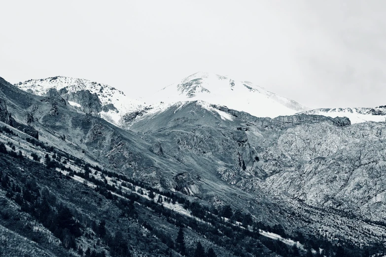 a mountain range is covered with snow in the distance