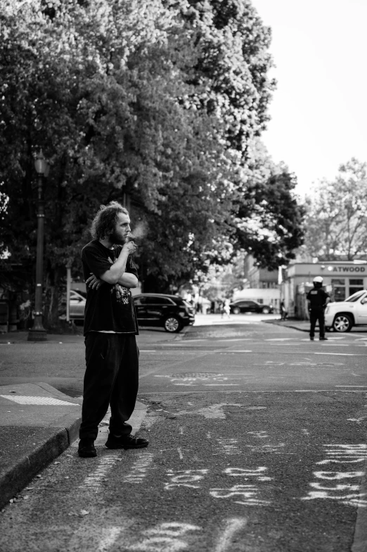 a boy in the street looks up at a traffic light