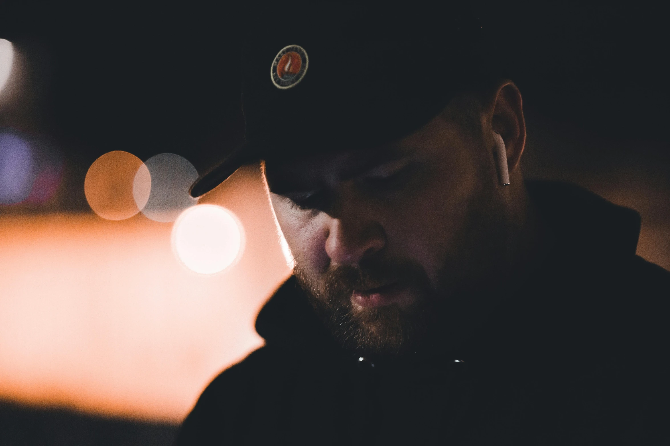 a man wearing a hat talking on his phone