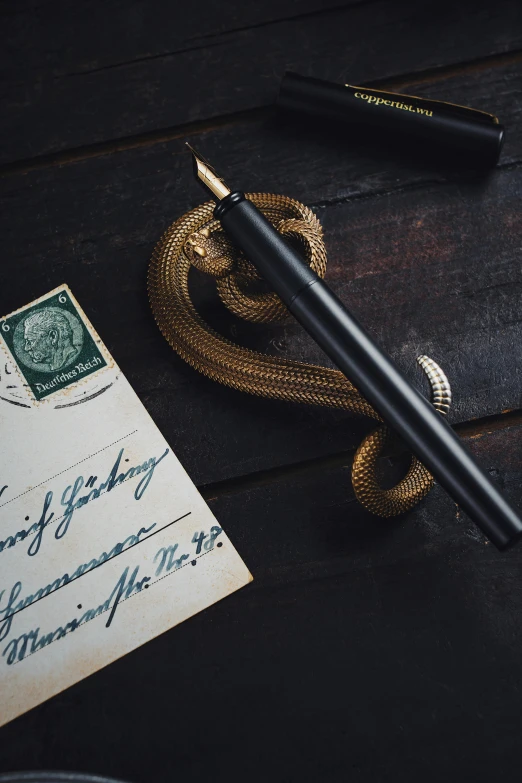 a pen and envelope on a wooden table