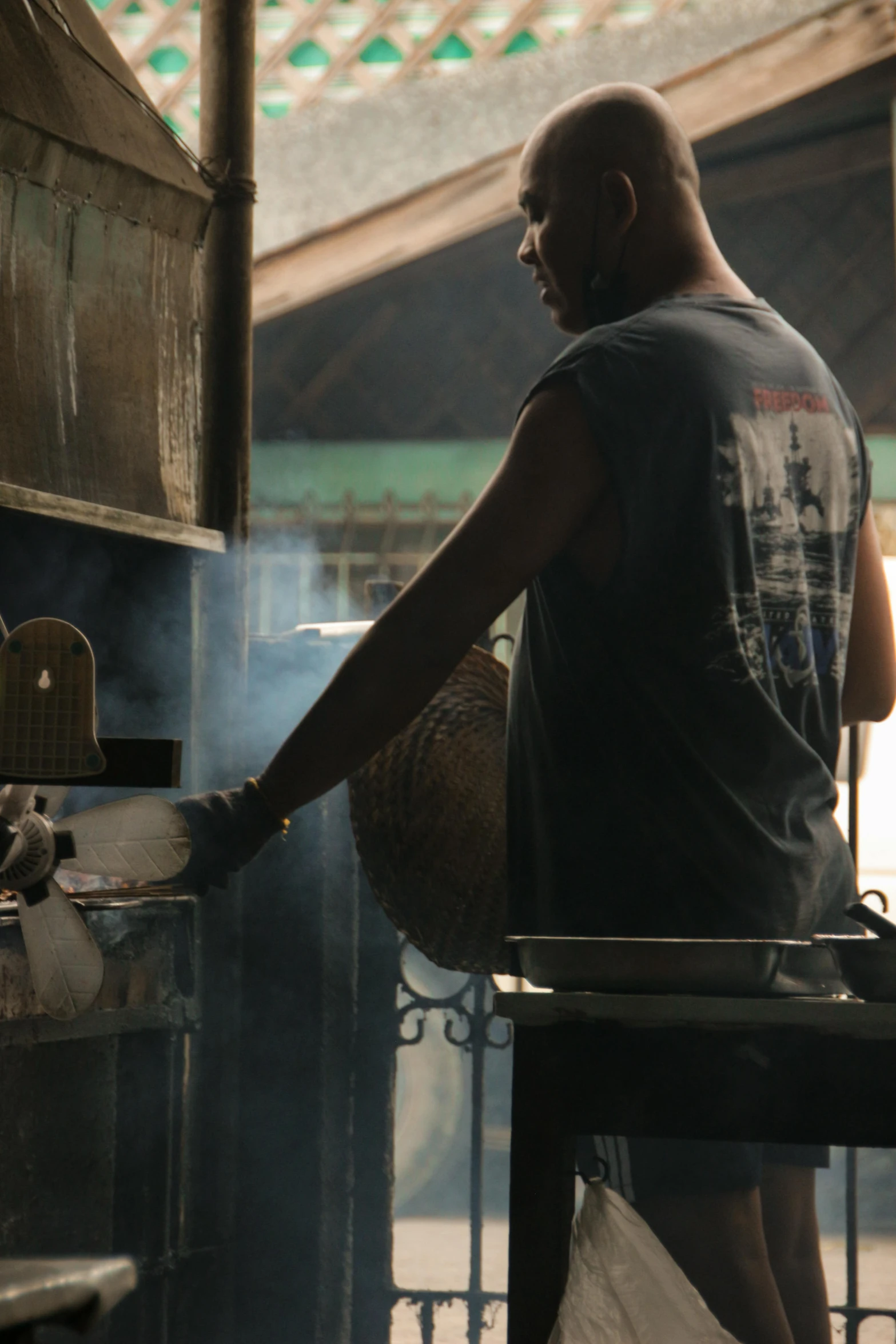 a person standing near some containers that are on a grill