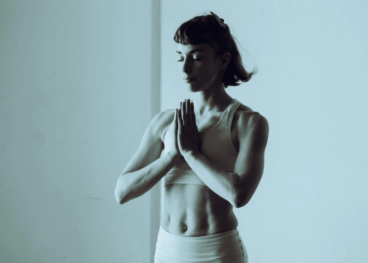 a young woman in the middle of praying