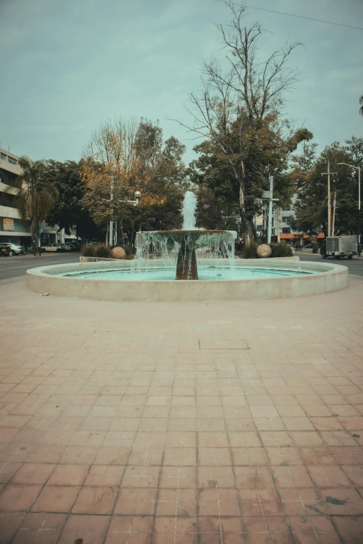 an image of a fountain in the middle of a street