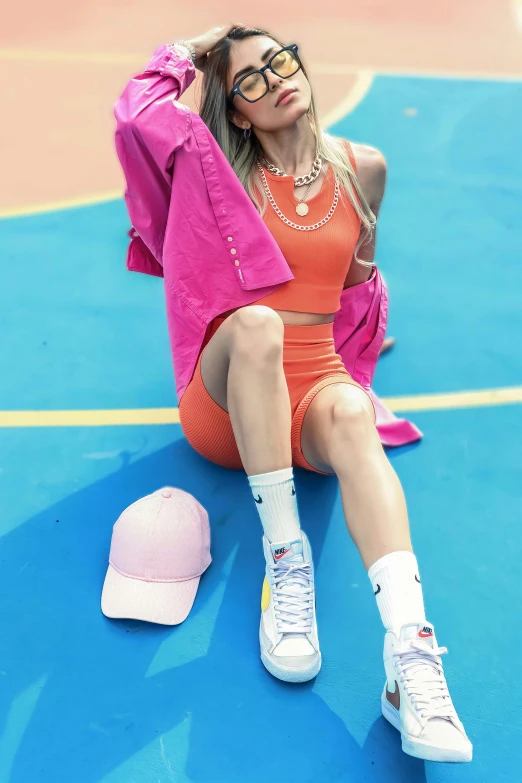 a woman is sitting on the court with a basketball shoe