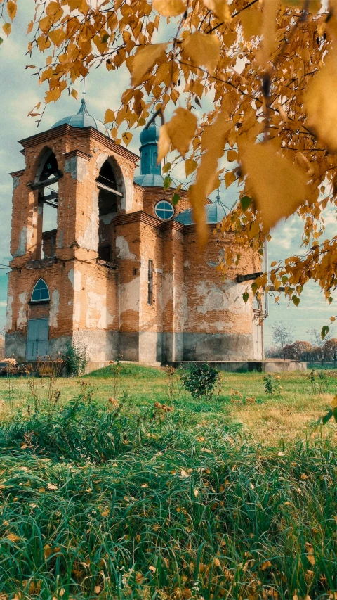 an old building sitting behind a few trees