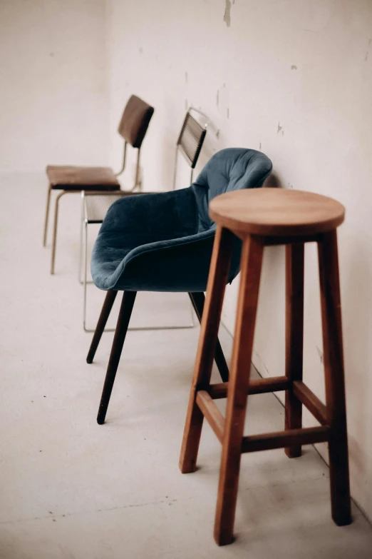 a chair and stool next to each other with barstools