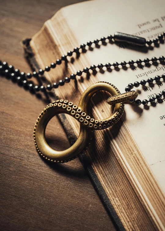 a book on a table with some rings on top