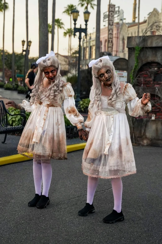 two girls in halloween costume looking like zombies