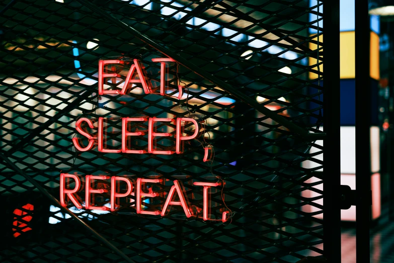 a street sign that says eat, sleep and repeat