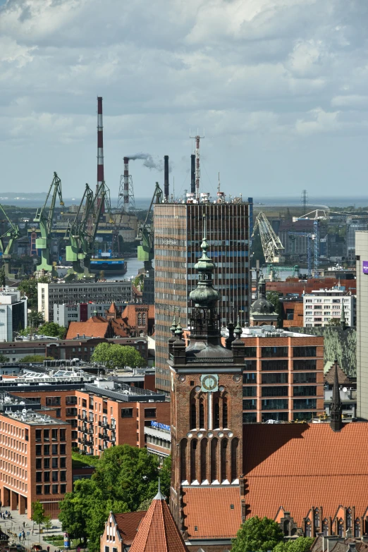 an aerial view of industrial area, including buildings and pipes