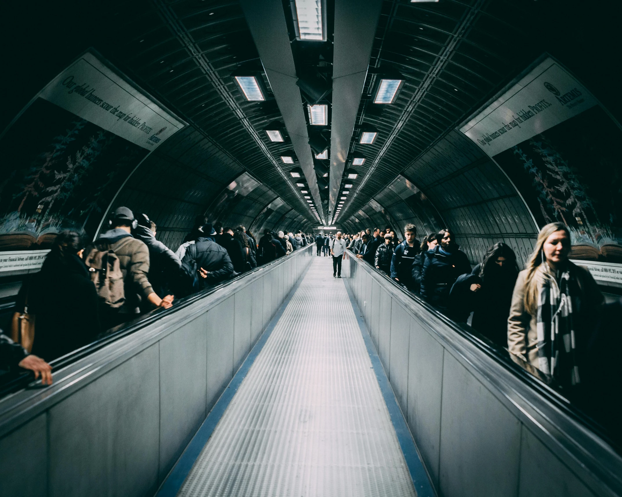 some people are standing up in a metro or airport