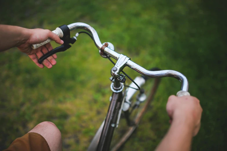 a close - up of a person riding a bike on a lawn