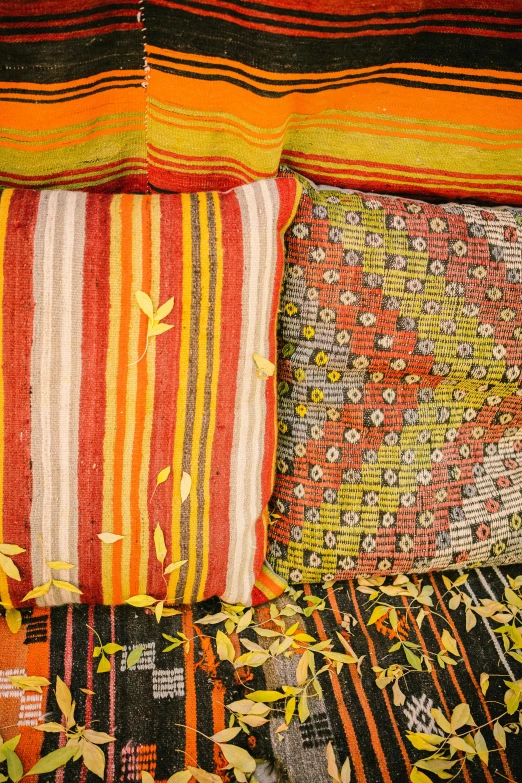 several different colored striped pillows in a room