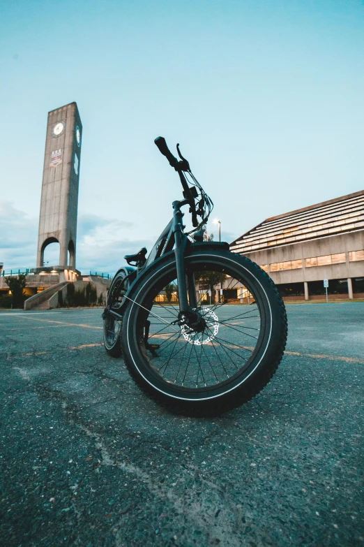 a black bike parked outside of a building