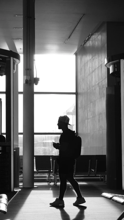 man is walking through the building alone during the day