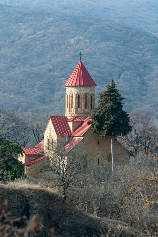 a church stands in the distance overlooking a mountainous area