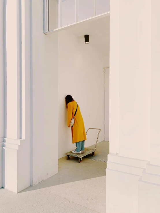 a woman on a skateboard walking around outside a building