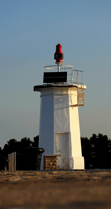 a lighthouse that is standing with people on top