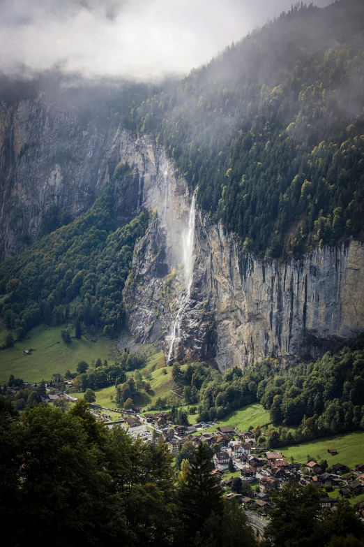 a large waterfall near the edge of some mountains