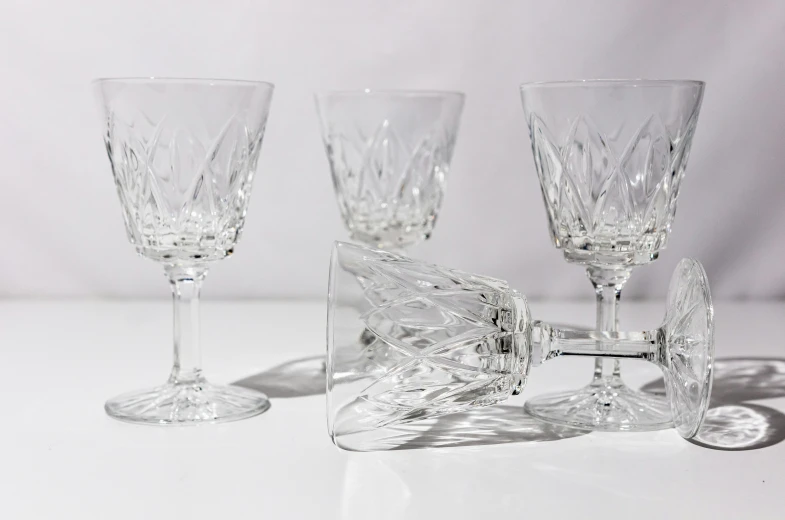 three glass goblets sitting on a table top