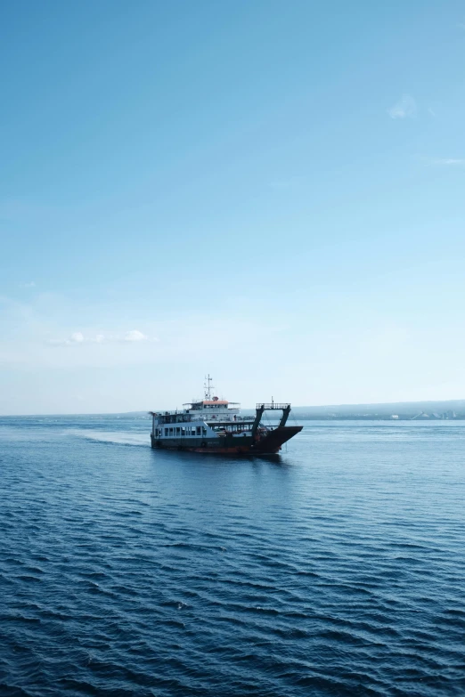 a large boat is floating on a lake