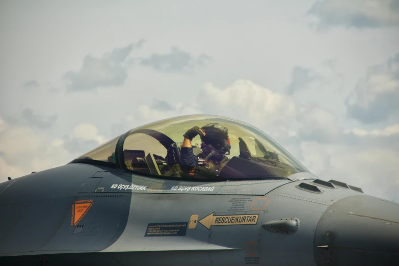the fighter pilot is in the cockpit of his plane