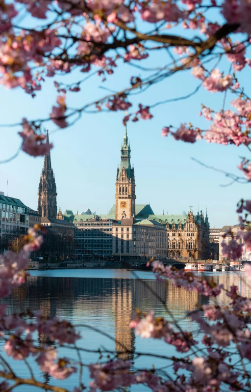 a city building, with a tower and some water