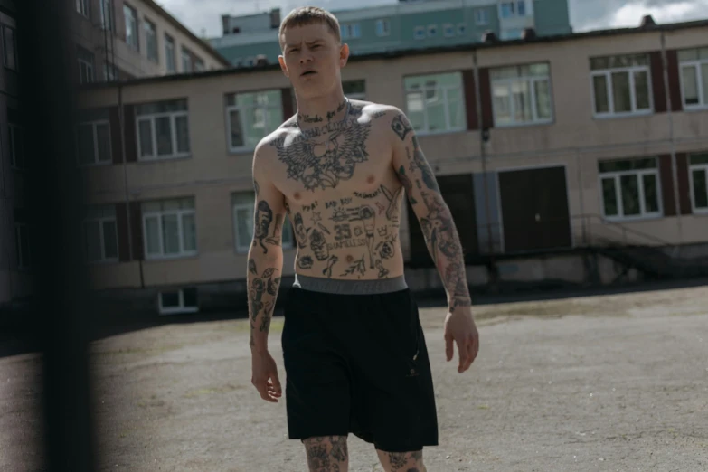 a man standing in a parking lot wearing  and shorts