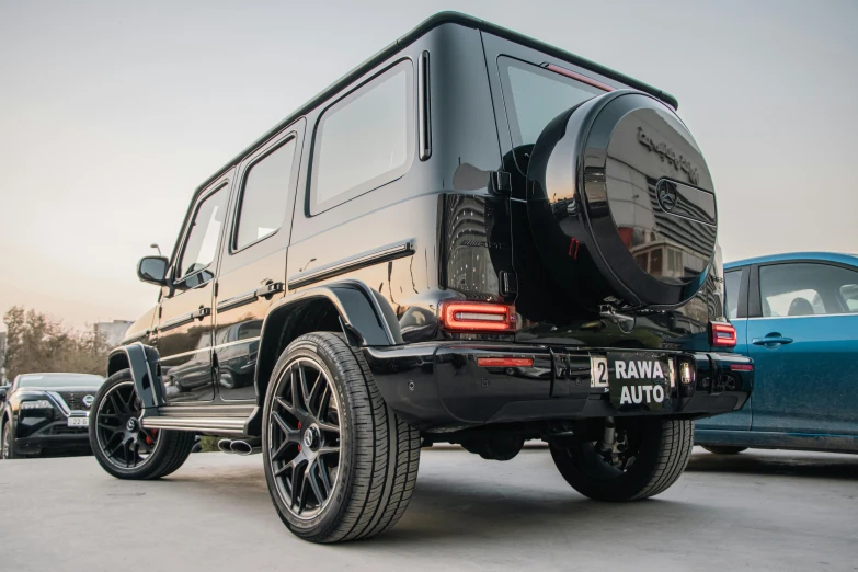 the jeep with the giant exhaust system is parked in front of other cars