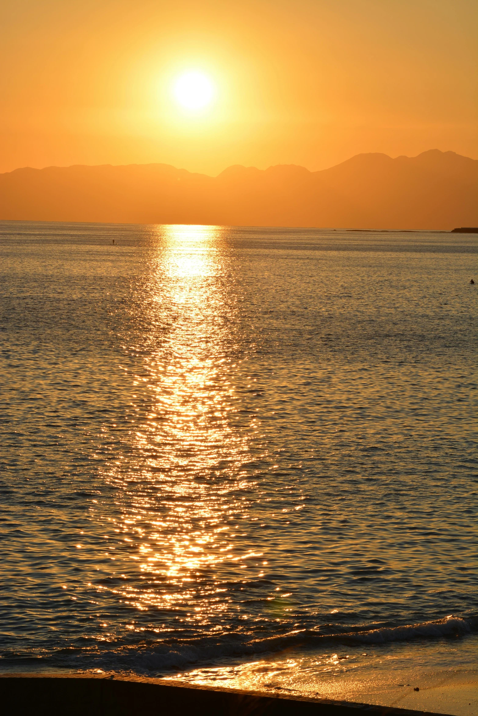 a bright yellow sunset is shown above the ocean