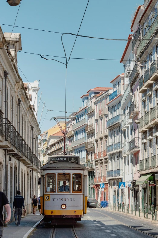 a trolley traveling down a narrow city street