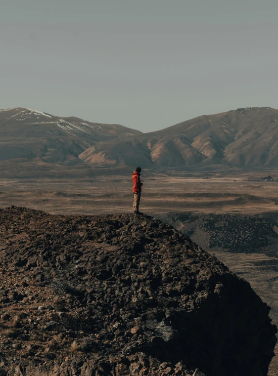 a person with a backpack on top of a mountain