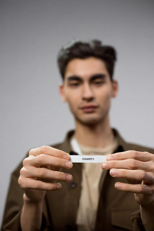 a man holding up his name tag