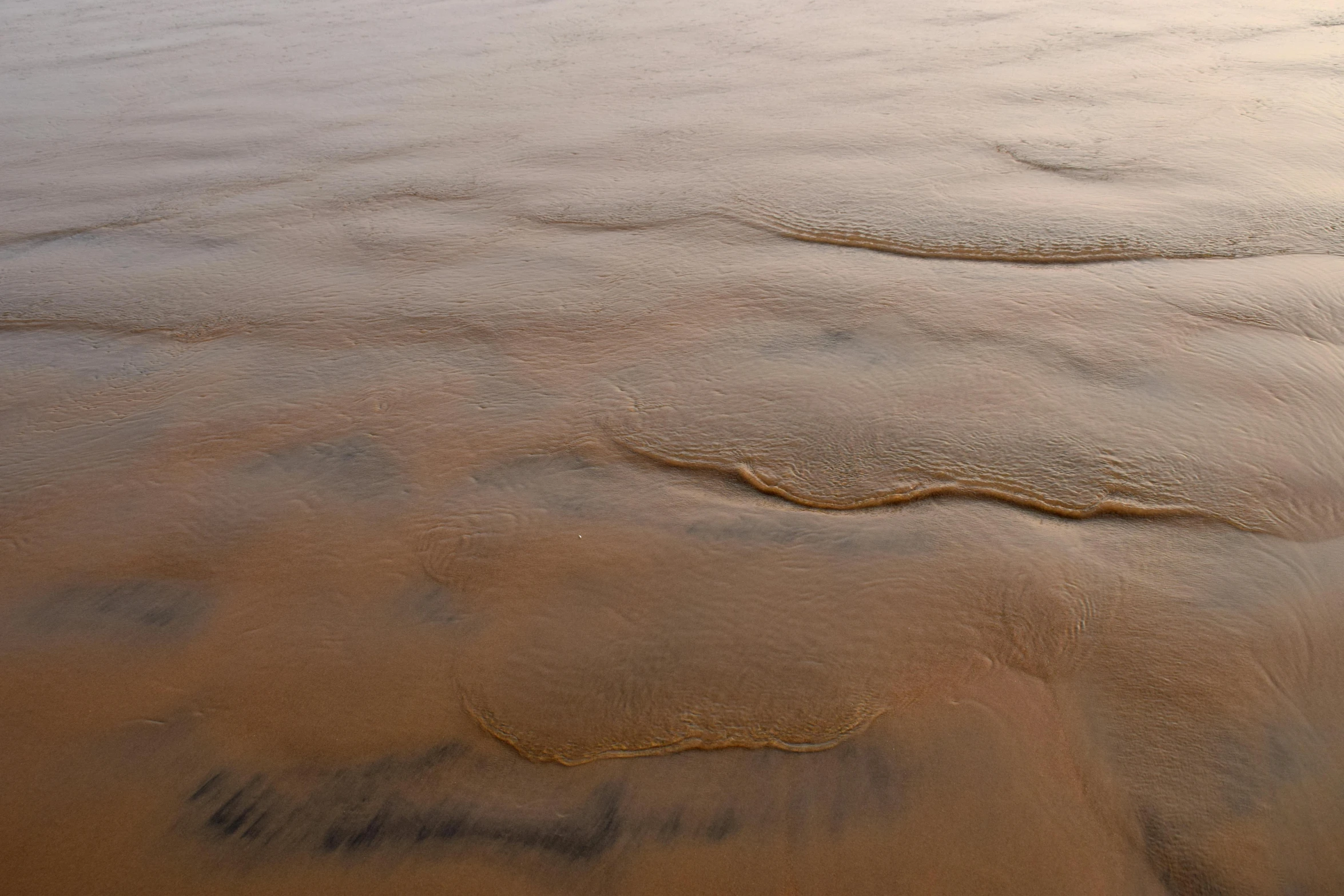 the water of the river is wet and covered with sand