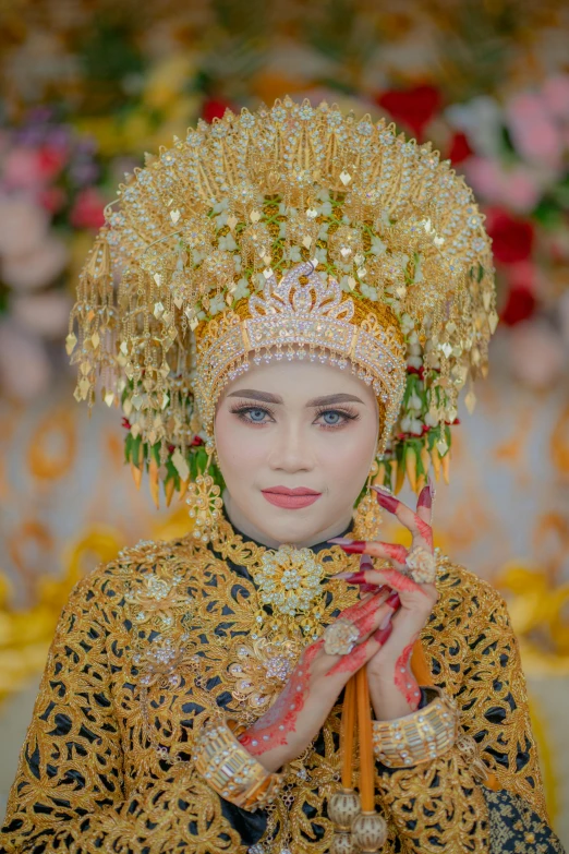 a woman with blue eyes wears traditional thai costume