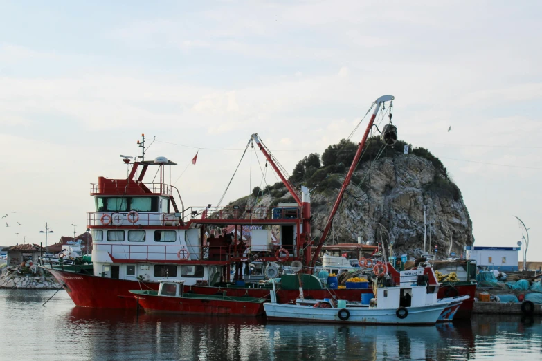 boats are docked at the pier on the sea