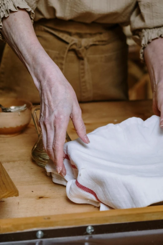 the person uses his hands to pull a napkin off