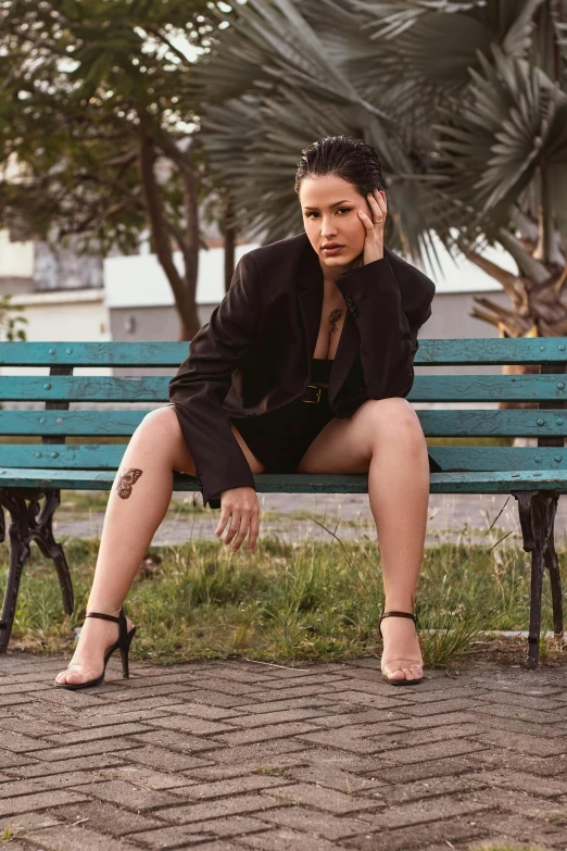 woman on cell phone sitting on a blue bench