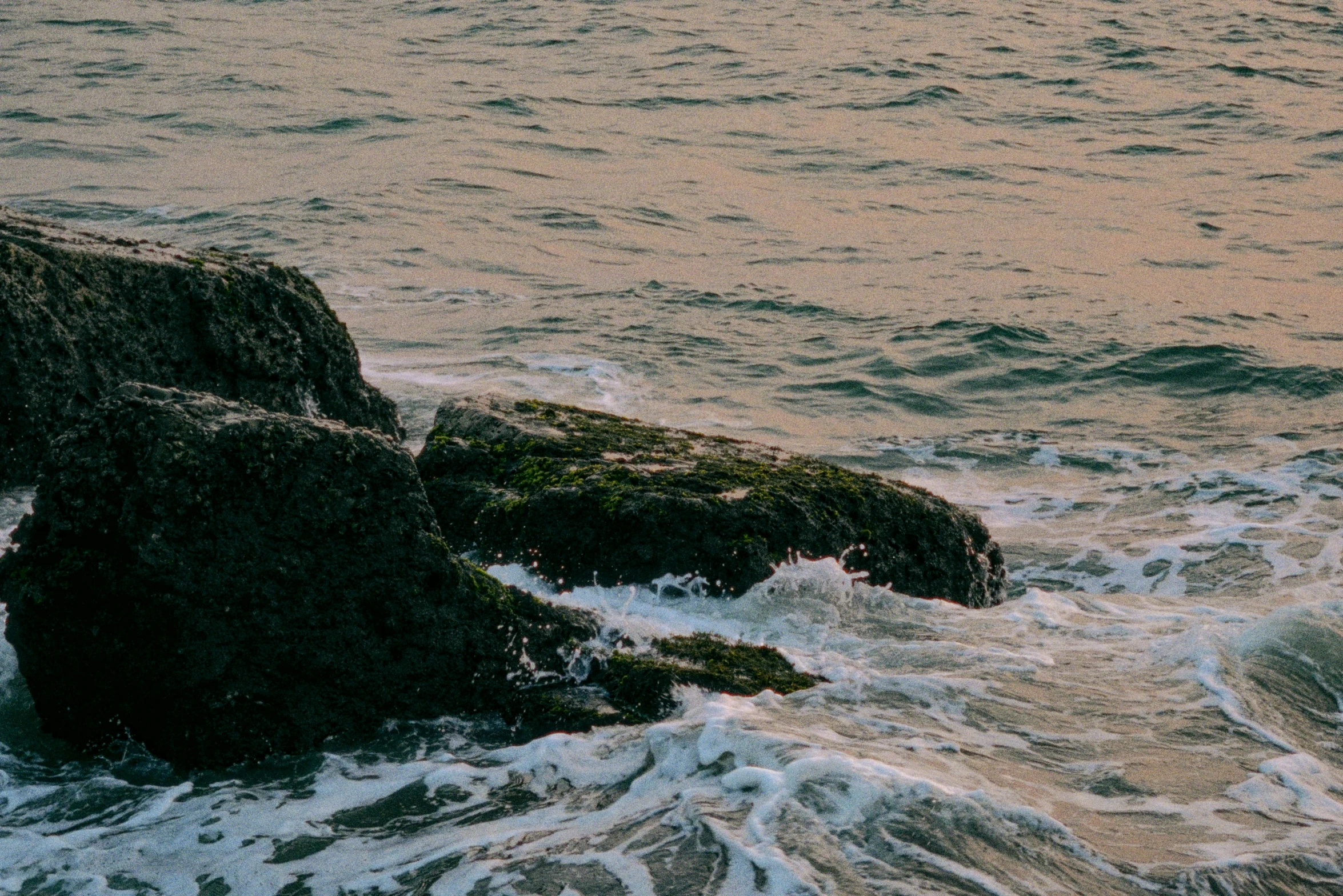 rocks in the sea that are washed up and covered with water