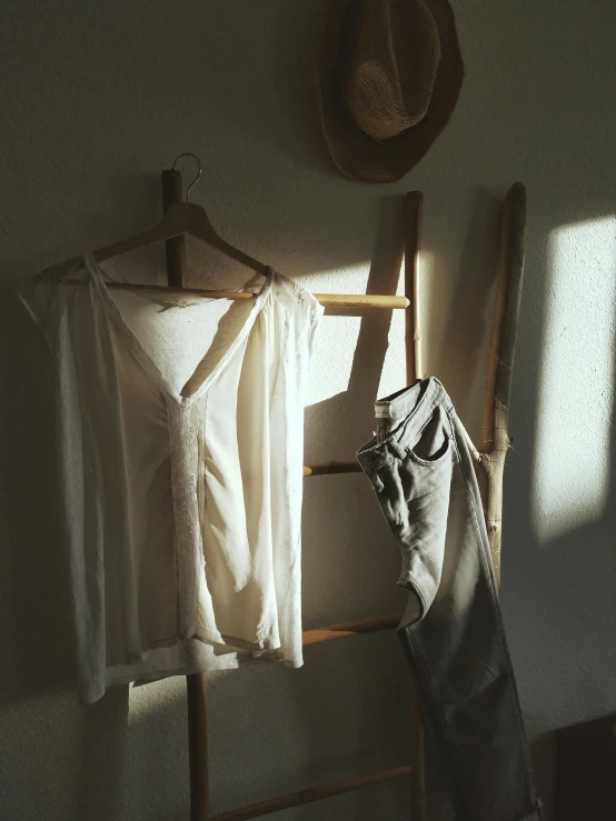 a wooden bench with white clothes hanging on it