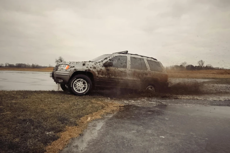 the front view of a dirty truck on a dirty road