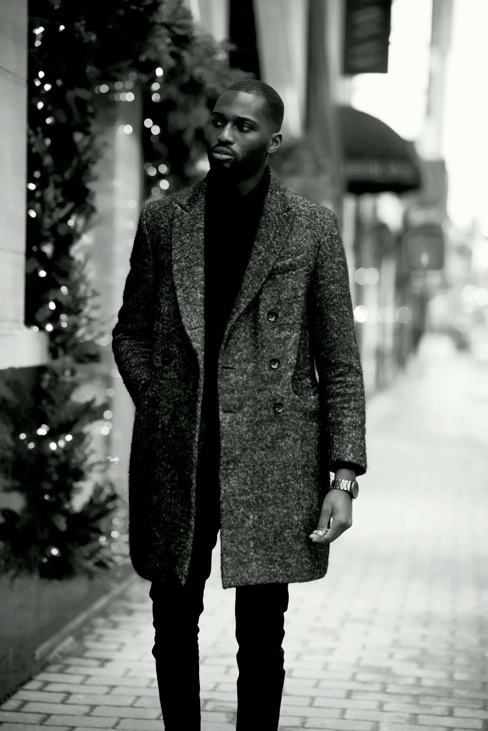 a man standing in the middle of the sidewalk in winter