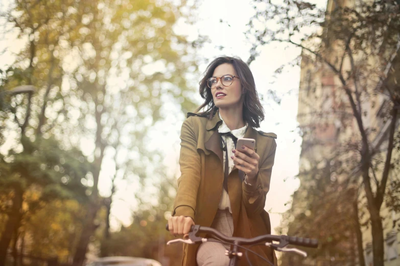 woman riding her bike with coffee in hand