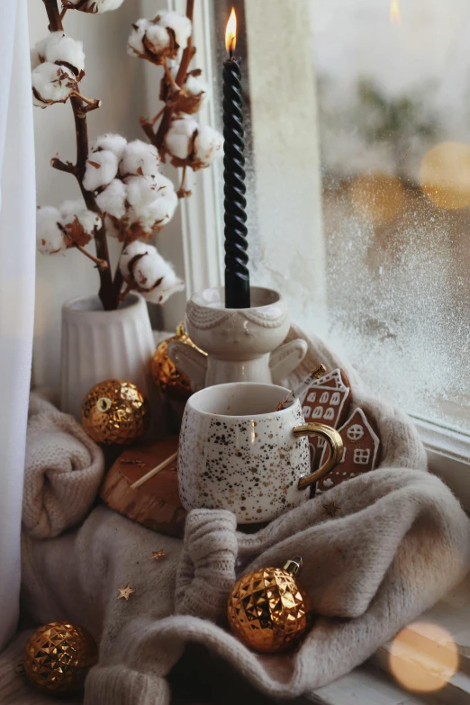 the windowsill has a vase with a candle on it