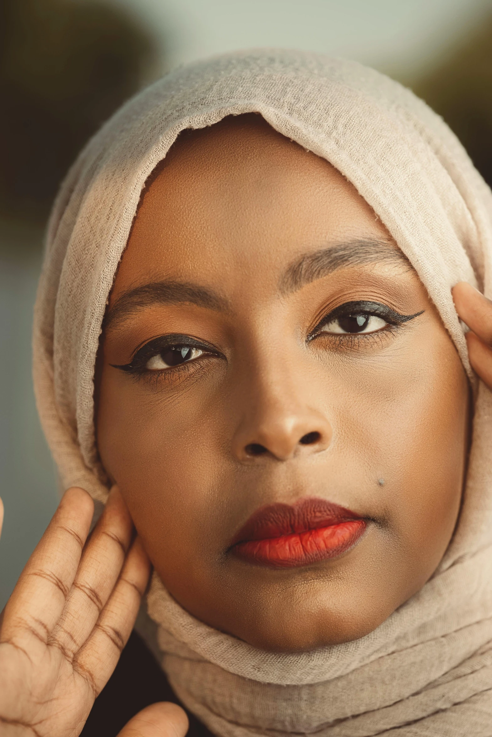 a woman in a white turban posing for the camera