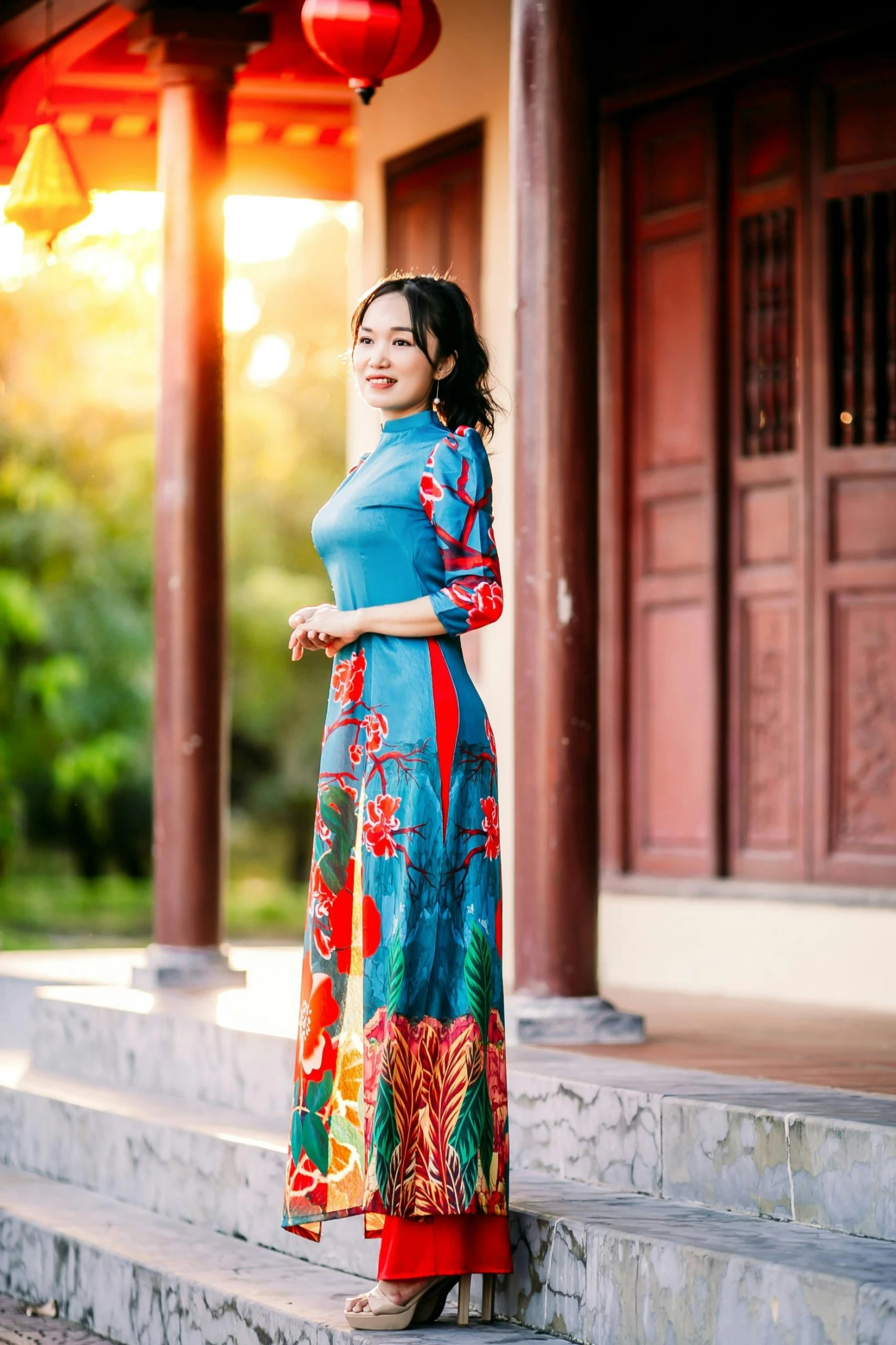 a beautiful woman in a blue dress posing on a porch