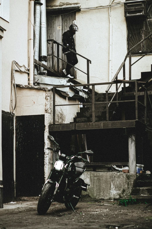 a black and white po of a motorcycle outside a building