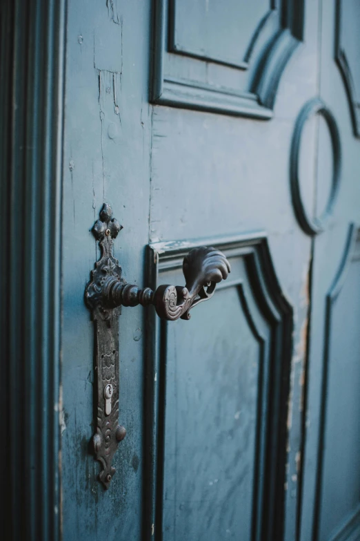 an ornate door handle with a unique iron lock on a door