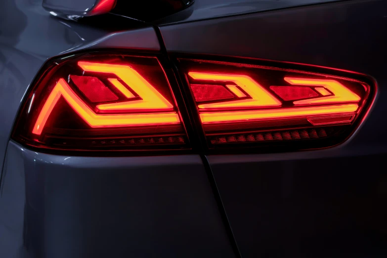 the tail light of a silver sedan